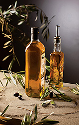 Photo: Two bottles of olive oil standing on a table. Link to photo information