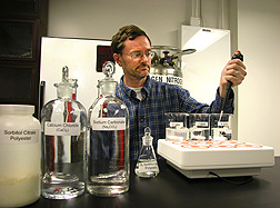 Chemist performs a test to determine how much sorbitol citrate is needed to prevent scale, the crusty buildup of calcium carbonate from so-called hard water: Click here for full photo caption.