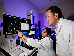 Agricultural engineer Bosoon Park (right) and postdoctoral research associate Jaya Sundaram examine a hyperspectral microscope image of an experimental substrate developed for SERS food-safety analyses: Click here for photo caption.
