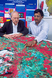 Meteorologist and NASS employee observe a remote-sensing map: Click here for full photo caption.