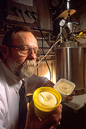 Chemist holds an open container of margarine: Click here for full photo caption.