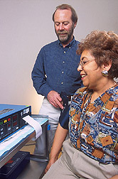 Endocrinologist checks a volunteer's blood pressure: Click here for full photo caption.