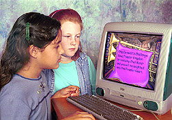 Two 4th-grade students play a computer game: Click here for full photo caption.