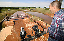 Hydraulic engineer records the test for use in computer modeling: Click here for full photo caption.