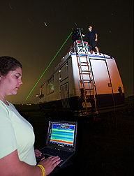 Technician examines the output from the LiDAR mounted atop the mobile laboratory: Click here for full photo caption.