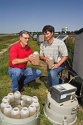 Soil scientist and biologist inspect samples of water runoff: Click here for full photo caption. 