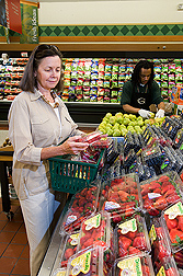 A shopper selects berries and other fruit for their ORAC (Oxygen Radical Absorbance Capacity) value: Click here for full photo caption.