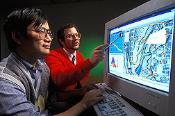Computer programmer and agricultural engineer discuss the design of watershed model interface screens: Click here for full photo caption.