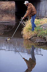 Technician collects a sample from a watershed in Ames, Iowa: Click here for full photo caption.