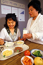 Nursing assistant Rowena Mallari (left) samples a low-carotene lunch served by dietitian Doris DeLeon.