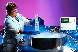 Technician examines seeds preserved in a vat of liquid nitrogen.