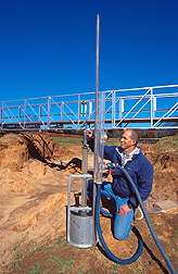 Hydraulic engineer conducts a jet test to evaluate soil erodibility. Click here for full photo caption.