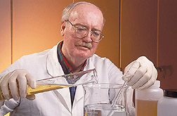 Chemical engineer prepares an enzyme processing solution: Click here for full photo caption.