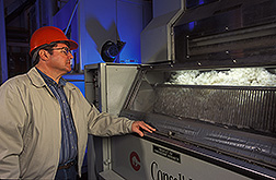 Textile technologist monitors the performance of a roller gin stand: Click here for full photo caption.