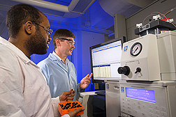 Technician (left) and plant physiologist analyze the pectic fragment composition of a prebiotic fraction from orange peel: Click here for full photo caption.