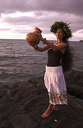 A ceremonial ipu is held by traditional dancer Kanoe Lake: Click here for photo caption.
