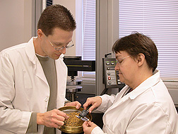 Agricultural engineer and technician examine the quality of pelleted animal feed made from DDGS: Click here for full photo caption.