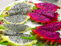 Slices of fresh dragon fruit, revealing its edible flesh: Click here for photo caption.