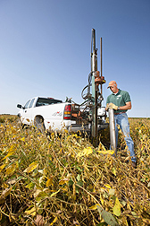 Technician Kent Heikens prepares a large core sampler to take a core sample of the wood chip bioreactor beneath a soybean field for lab analysis of denitrification rates and bacterial populations: Click here for photo caption.