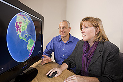 Physical scientist Martha Anderson and research leader Bill Kustas view a global scale map of evapotranspiration generated with the ALEXI model: Click here for full photo caption.