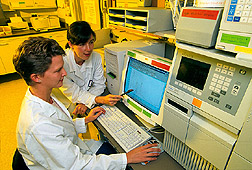 Nutritionist (right) and technician review an HPLC chromatogram. Click here for full photo caption.