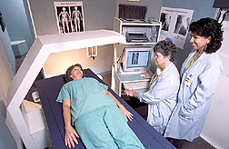 Nutritionist and nurse prepare to measure body composition of a potential participant in an earlier study. Link to photo information