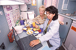 Nutritionist and psychology technician enter information into a database: Click here for full photo caption.