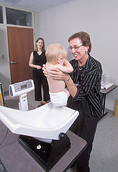 Nutritionist weighs a 1-year-old boy: Click here for full photo caption.