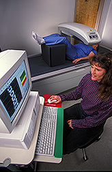 Photo: Physiologist makes a bone density measurement of a research volunteer. Link to photo information
