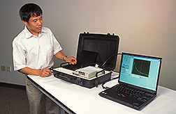 Chemist tests a portable fluorometer: Click here for full photo caption.