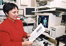 Assistant professor of pediatrics examining a bone density scan: Click here for full photo caption.