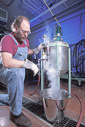 Microbiologist operates a recirculating batch jet cooker: Click here for full photo caption.