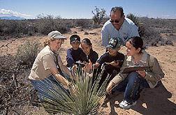 Nature Park director and station superintendent work with children on a field trip: Click here for full photo caption. 