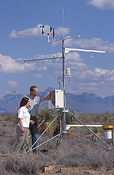 Technician and manager of Network site reset weather recording equipment: Click here for full photo caption.
