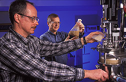 Chemical engineer and research leader carry out a fermentation of hull-less barley: Click here for full photo caption.