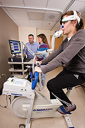 Physiologists examine results of University of California-Davis clinical specialist's calorie consumption and fat oxidation while she test-rides a cycle ergometer: Click here for full photo caption.