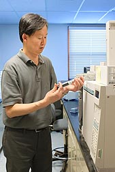 Entomologist Yong-Biao Liu injects fumigant samples into a gas chromatograph to determine phosphine concentrations: Click here for full photo caption.