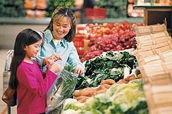 Parents who want their kids to eat more fruits and vegetables may involve the youngsters in helping to select items from the supermarket produce section: Click here for photo caption.