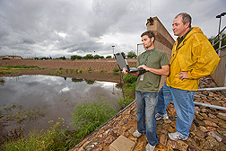 In Arizona, hydraulic engineer David Goodrich (right) and technician Jim Riley are working to improve modeling estimates of watershed-level rainfall runoff and erosion--information that will help guide decisions on where, and how many, juniper trees can be harvested without having an adverse effect on runoff and erosion: Click here for photo caption.