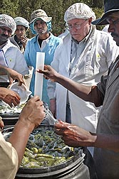 ARS chemist Roger McFeeters (second from right), who led the Raleigh laboratory from 2003 to 2011, discusses pickle making with producers in India.