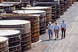 In 1986, ARS's Henry Fleming (right), best known for helping find the cause of â€œbloatingâ€� during cucumber fermentation, walks among wooden open-top tanks used by the pickle industry with North Carolina State University professor Ervin Humphries (left) and Douglas Brock of the Mt. Olive Pickle Company.