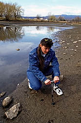Technician Robin Montenieri collects a soil sample. Click here for full photo caption.