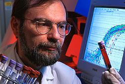 Biochemist searches for genetic mutations in blood samples. Click here for full photo caption.