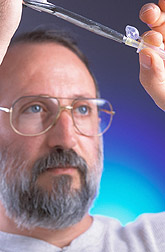 Molecular biologist performs a step used for cloning a gene: Click here for full photo caption.