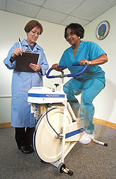 Nutritionist prepares to measure participant's heart rate after vigorous exercise: Click here for full photo caption.
