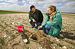 Soil scientist and technician make a quick assessment of erosion damage: Click here for full photo caption.