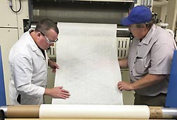 ARS researchers inspect nonwoven fabric for use in cotton-based wipes. Link to photo information