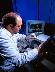 Microbiologist uses thin-layer chromatography. Click here for full photo caption.
