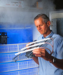 Agricultural engineer Bailey Mitchell demonstrates an electrostatic air cleaning system. Link to photo information.