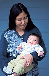 Woman holds baby: Click here for full photo caption.